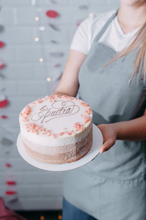 A beautiful mousse cake in the hands of a pastry chef