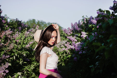 A fashionable girl with dark hair, a spring portrait in lilac tones in summer. Bright professional makeup.の写真素材