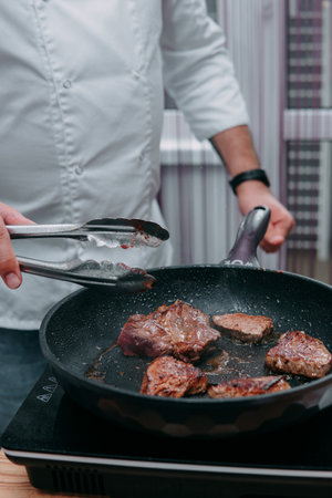 Raw beef meat for cooking steak. Raw beef is sliced, cooking meat for cooking steak in a cooking class.の写真素材