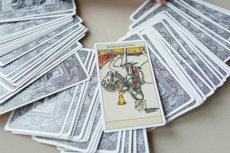 TVER, RUSSIA - FEBRUARY 11, 2023. Tarot cards, Tarot card divination, esoteric background. A woman makes a layout on the cards at the table. Divination, predictions on tarot cards.のeditorial素材