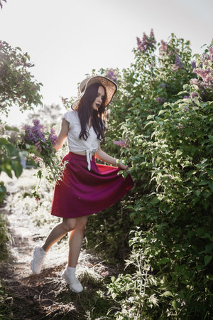 A fashionable girl with dark hair, a spring portrait in lilac tones in summer. Bright professional makeup.の写真素材