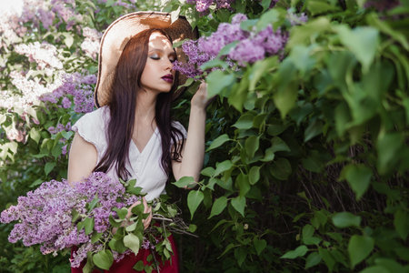 A fashionable girl with dark hair, a spring portrait in lilac tones in summer. Bright professional makeup.の写真素材