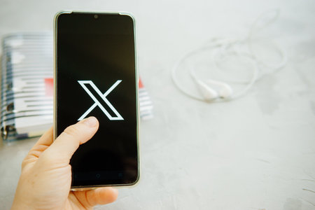 July 25, 2023, Russia. The logo in the form of the letter X displayed on the smartphone. Twitter rebranding, and implementation of X.のeditorial素材
