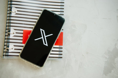 July 25, 2023, Russia. The logo in the form of the letter X displayed on the smartphone. Twitter rebranding, and implementation of X.のeditorial素材
