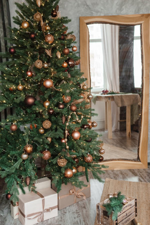 Bronze balls on the Christmas tree. Christmas tree design decorations. The concept of celebrating New Year and Christmas.の写真素材
