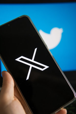 July 25, 2023, Russia. The logo in the form of the letter X displayed on the smartphone. Twitter rebranding, and implementation of Xのeditorial素材