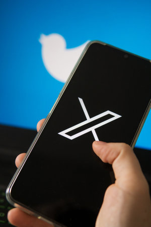 July 25, 2023, Russia. The logo in the form of the letter X displayed on the smartphone. Twitter rebranding, and implementation of X.のeditorial素材