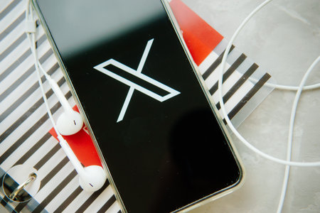 July 25, 2023, Russia. The logo in the form of the letter X displayed on the smartphone. Twitter rebranding, and implementation of X.のeditorial素材