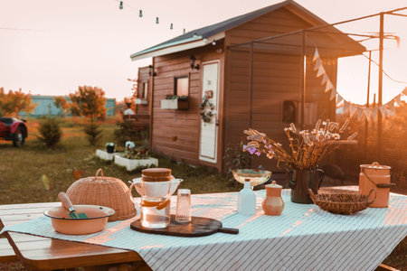 A covered wooden table in the courtyard of a country house. Country life, life in the country