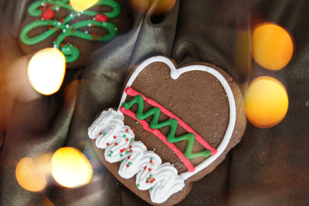 Banner for Christmas and New Year gingerbread. Christmas trees, toys, snowmen, garlands on a background of brown silk fabric. Bright bokeh.の写真素材