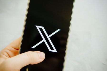 July 25, 2023, Russia. The logo in the form of the letter X displayed on the smartphone. Twitter rebranding, and implementation of X.のeditorial素材