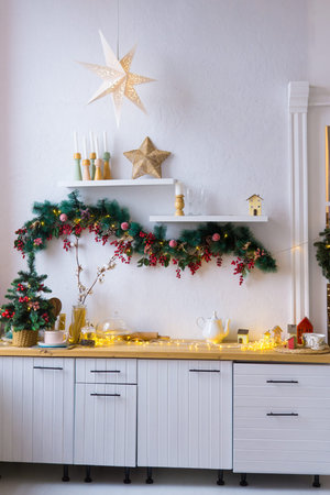 Kitchen interior decorated for Christmas and New Year. New Years interior in red and white tones.の写真素材