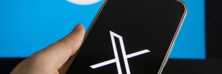 July 25, 2023, Russia. The logo in the form of the letter X displayed on the smartphone. Twitter rebranding, and implementation of X.のeditorial素材