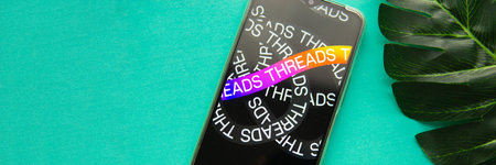 Tver, Russia - July 15, 2023, threads logo on the smartphone screen, on a green background. The...