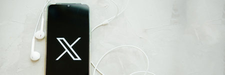 July 25, 2023, Russia. The logo in the form of the letter X displayed on the smartphone. Twitter rebranding, and implementation of X.のeditorial素材