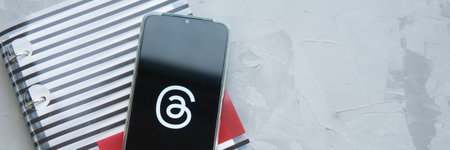 Tver, Russia - July 15, 2023, threads logo on the smartphone screen, on a gray background. The...