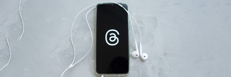 Tver, Russia - July 15, 2023, threads logo on the smartphone screen, on a gray background. The...