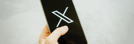 July 25, 2023, Russia. The logo in the form of the letter X displayed on the smartphone. Twitter rebranding, and implementation of X.のeditorial素材