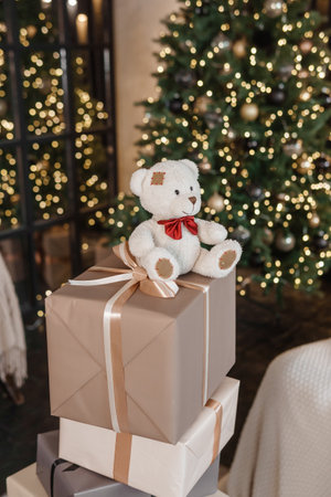 Designer Christmas tree decoration with lights. The concept of celebrating New Year and Christmas. Gifts in craft packaging under the Christmas tree.の写真素材