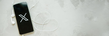 July 25, 2023, Russia. The logo in the form of the letter X displayed on the smartphone. Twitter rebranding, and implementation of X.のeditorial素材