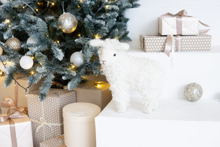 Designer Christmas tree decoration with light decorations. The concept of celebrating New Year and Christmas. Gifts in craft packaging under the Christmas tree.の写真素材