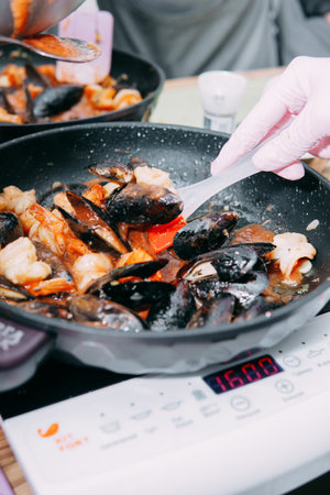 Tomato soup with mussels. The process of cooking tomato soup from mussels in a cooking class....