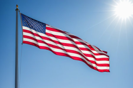 American flag develops against a blue sky. A symbol of country and freedom.の写真素材