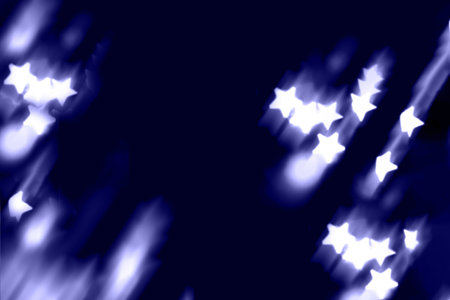 Blurry garland lights on a dark background. Festive Christmas and New Year background. Soft focus