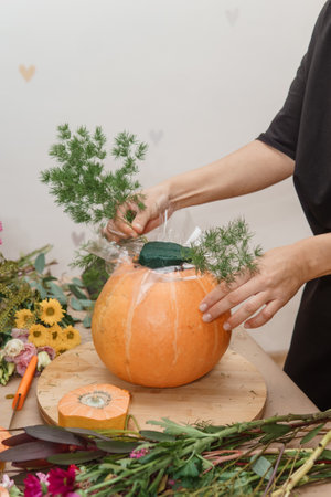 Creating a floral composition in a pumpkin. Making decor with your own hands.の写真素材