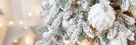 A Christmas tree sprinkled with artificial snow in the New Year's interior. Background for New Year wallpapers and postcards.の写真素材
