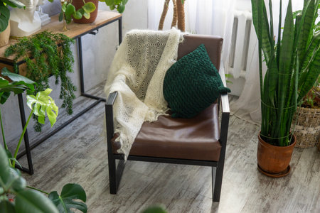 A fragment of the interior with a variety of indoor plants and plaster sculptures. Urban jungle concept. Biophilia design.の写真素材