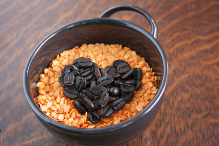 Valentines coffee bean heart in a mug of lentils