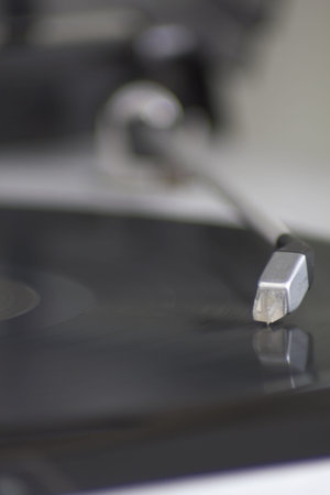 Portrait format of close up of arm on record player