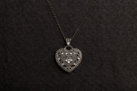 Steel heart on the black wool background