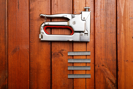 Furniture stapler on wood backgroundの写真素材