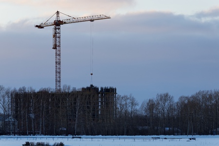 Construction site with cranes silhouette in the evening. Horizontal photo.の写真素材