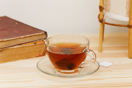 Cup of tea and books on woody tableの写真素材