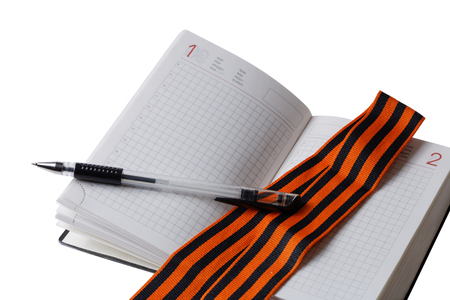 Russian St. George ribbon and diary isolated on whiteの写真素材