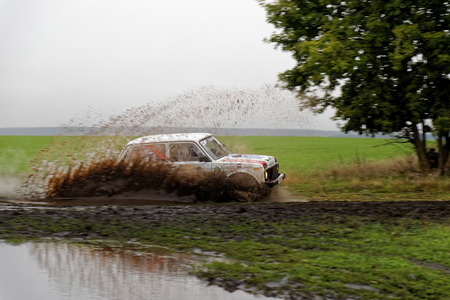 Ulyanovsk, Russia - September 24, 2016. Rally raid "Hills of Russia". SUV Rally on a dirt road between the forest and field.のeditorial素材