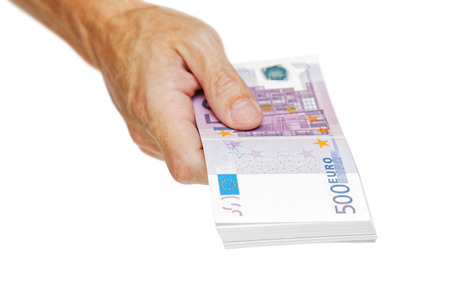 A man's hand gives out a bundle of euro banknotes isolated on white. Financial concepts. Money in the hand.の写真素材