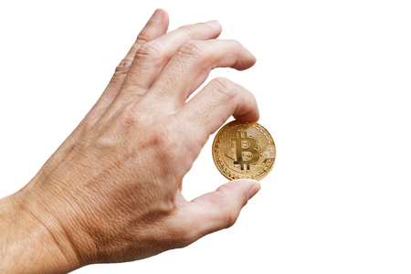 A mans hand holding a golden bitcoin - symbol of international virtual cryptocurrency. Isolated on white.の写真素材
