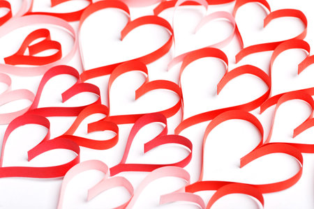 Abstract background of red contours of hearts on a white background. Concept on Valentine day or...