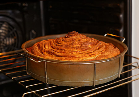 Homemade pastry rolling pie with apples and cinnamon is cooked in the oven on home cuisine