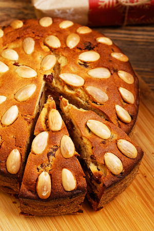 Closeup homemade almond cake on wooden table. Shallow focus.の写真素材