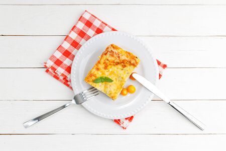 Portion of homemade lasagna on white wooden table. Mediterranean italian food. Top view.の写真素材