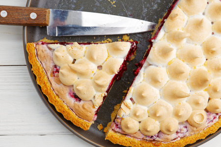 CLoseup homemade berry pie with meringue on white wooden table. Top view.