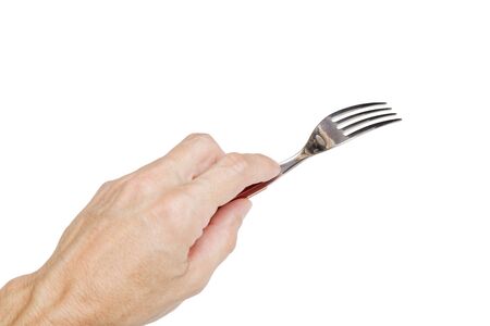 Humans left hand holding a silver fork isolated on white.の写真素材