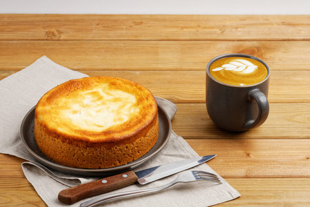 Homemade apple pie and cup of coffee cappuccino on wooden table.の写真素材