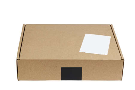 Closed brown cardboard box with blank white label. Box for parcel, delivery or packaging isolated on white background.の写真素材