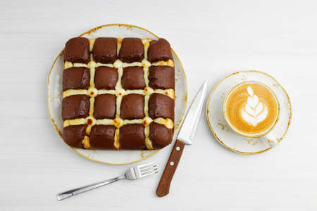 Homemade chocolate pie cheesecake and cup of coffee cappuccino on white wooden table. Top view.の写真素材